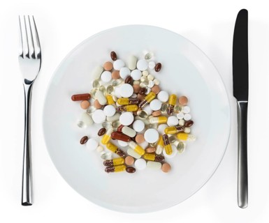 Drugs prepared as meal (close-up shot, selective focus) isolated on white background