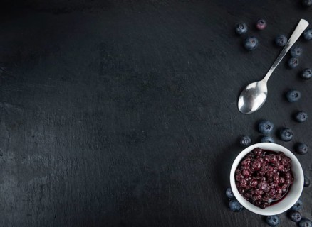 Some fresh Preserved Blueberries on a vintage slate slab, selective focus, close-up shot