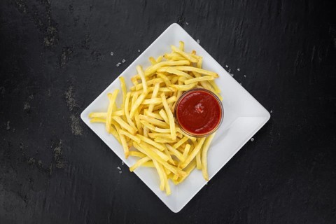 Portion of fresh made French Fries (close-up shot, selective focus)