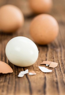 Some boiled Eggs (close-up shot, selective focus) on an old wooden table