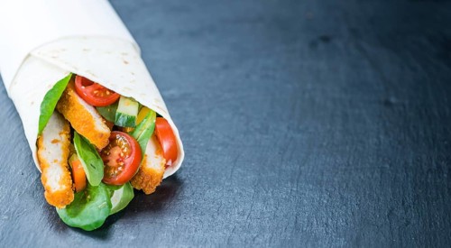 Chicken Wraps (selective focus) on a slate slab (close-up shot)