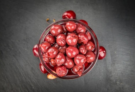Preserved Cherries on a vintage slate slab as detailed close-up shot, selective focus