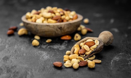 Roasted and salted nuts as detailed close up shot (selective focus)