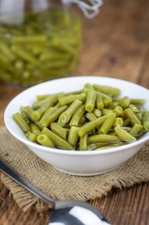 Preserved Green Beans as detailed close-up shot (selective focus) on vintage background