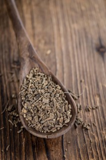 Dried Valerian roots (detailed close-up shot) on wooden background