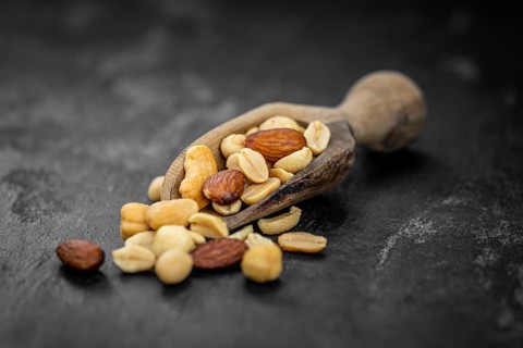 Roasted and salted nuts as detailed close up shot (selective focus)