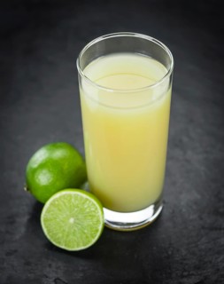 Some Fresh Lime Juice on a slate slab (close-up shot, selective focus)