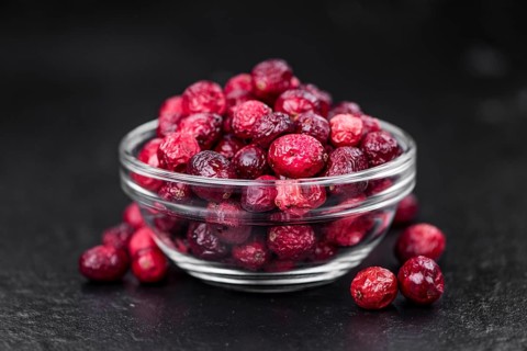 Portion of fresh made Dried Cranberries on a slate slab (selective focus)