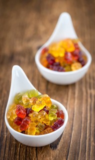 Fruity Gummy Bears (close-up shot) on an old wooden table