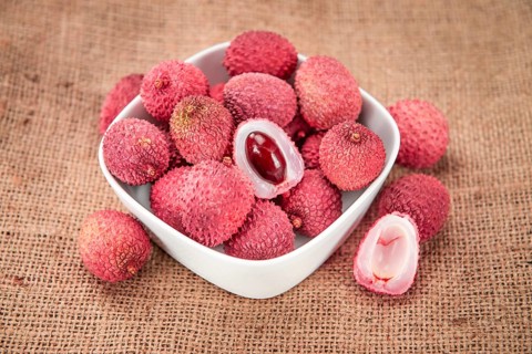 Lychees on a vintage background as detailed close-up shot (selective focus)