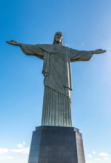 Christ the Redeemer statue in Rio de Janeiro, Brazil with blue sky in the background