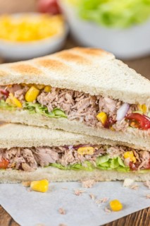 Homemade Tuna Sandwich (selective focus, close-up shot) on vintage wooden background