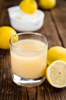 Fresh made Juice (lemon) on a vintage background (close-up shot)