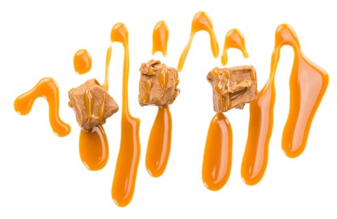 Caramel Sauce on a vintage slate slab (close-up shot, selective focus)