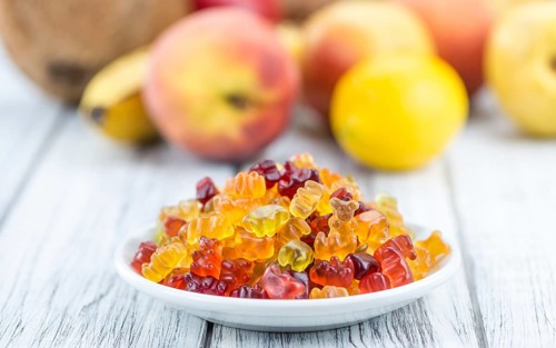 Wooden table with Gummy Bears (close-up shot, selective focus)