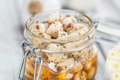 Portion of fresh Preserved Garlic (close-up shot, selective focus)