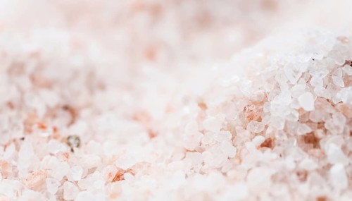 Pink Salt on a vintage background as detailed close-up shot (selective focus)