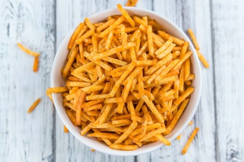 Potato Sticks (close-up shot, selective focus) on an old wooden table