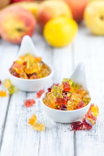 Fruity Gummy Bears (close-up shot) on an old wooden table
