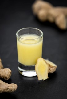 Fresh made Ginger Drink on a slate slab (close-up shot, selective focus)