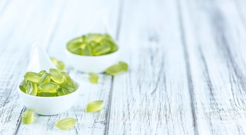 Portion of gummy candy (with lime taste) as close-up shot (selective focus)
