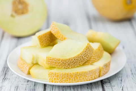 Honeydew Melon on a vintage background as detailed close-up shot (selective focus)