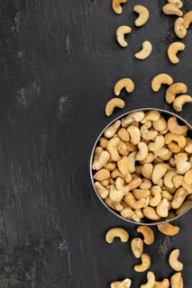 Portion of roasted Cashew Nuts (close up shot, selective focus)