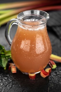 Rhubarb Juice on a rustic background (close up shot, selective focus)