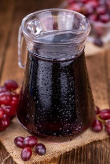 Fresh Red Grape Juice as detailed close-up shot (selective focus)
