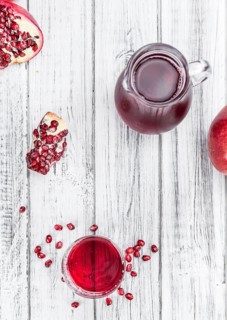 Pomegranate juice on a vintage background as detailed close-up shot (selective focus)