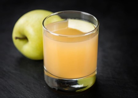 Fresh made Juice (apple) on a vintage background (close-up shot)