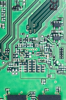 Green PCB (printed circuit board) close-up shot with a lot of electronic components