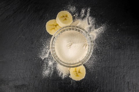 Portion of Banana Powder as detailed close up shot on a slate slab, selective focus