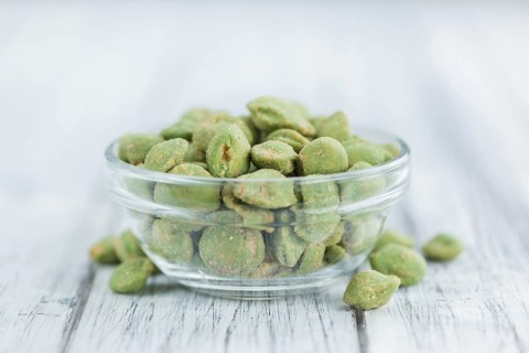 Wasabi Peanuts on a vintage background as detailed close-up shot (selective focus)