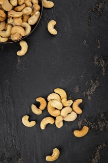 Portion of roasted Cashew Nuts (close up shot, selective focus)