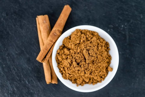 Fresh made Cinnamon Powder on a vintage background (close-up shot)