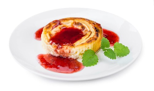 Cheesecake with Sauce isolated on white background (selective focus, close-up shot)