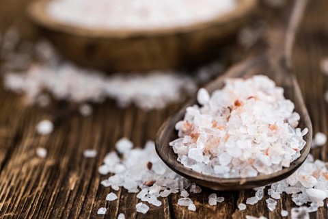 Himalayan Salt as high detailed close-up shot on a vintage wooden table (selective focus)