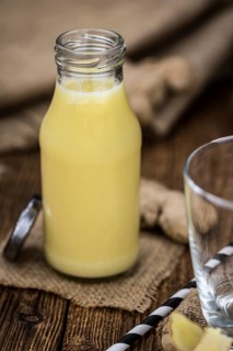 Portion of fresh Ginger Juice (selective focus, close-up shot)