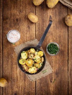 Portion of fresh homemade Fried Potatoes on an old wooden table (selective focus, close-up)