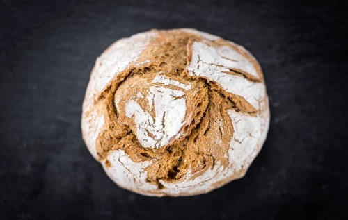 Fresh made Wholemeal Bun on a vintage background (close-up shot)