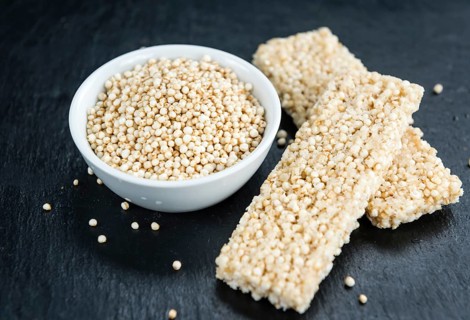 Slate slab with fresh made Quinoa Bars (close-up shot, selective focus)