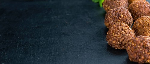 Wooden table with Falafels (close-up shot, selective focus)