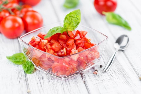 Diced Tomatoes on a vintage background as detailed close-up shot (selective focus)