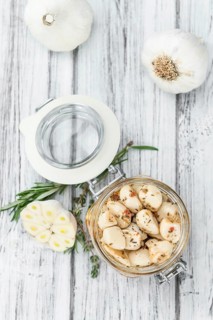 Fresh made Garlic (preserved) on a vintage background (close-up shot)