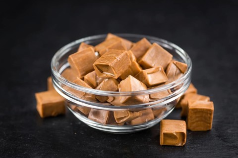 Caramel candy on a vintage slate slab (close-up shot, selective focus)