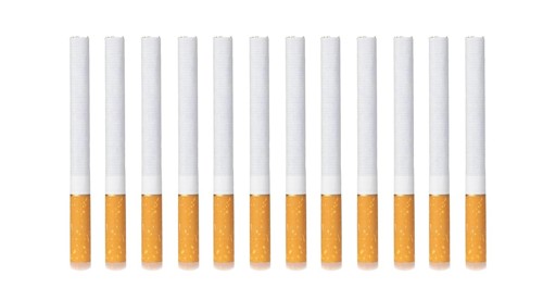Row, group of filter cigarettes isolated on white background