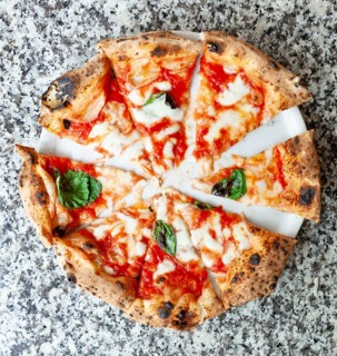 Top view of slices of pizza margherita on marble table