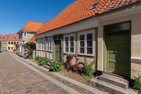 Old town of Rudkobing, renovated houses, colourful row of houses, decorative design, bicycle,