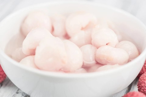 Fresh made Lychees (preserved) on a vintage background (close-up shot)